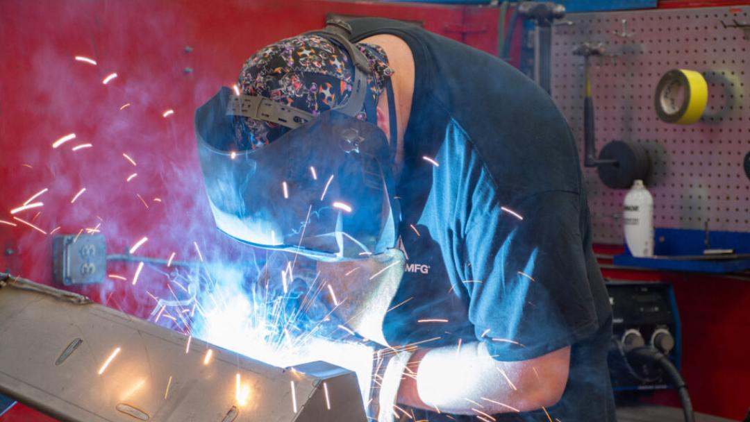 A welder welding with a mask