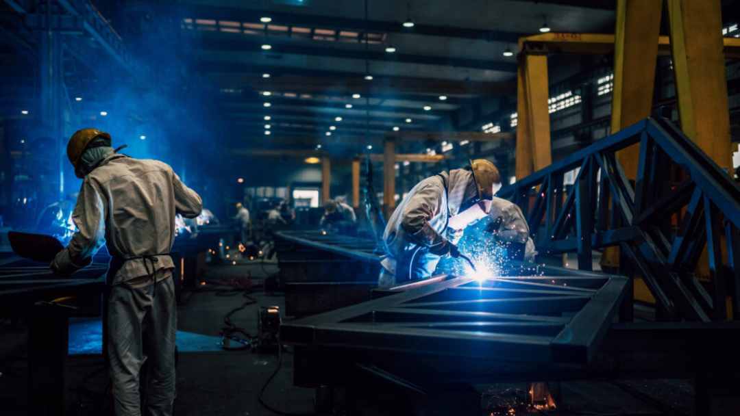 Welders welding with masks