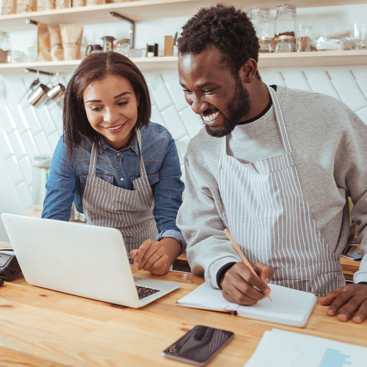 Two people working on a laptop together