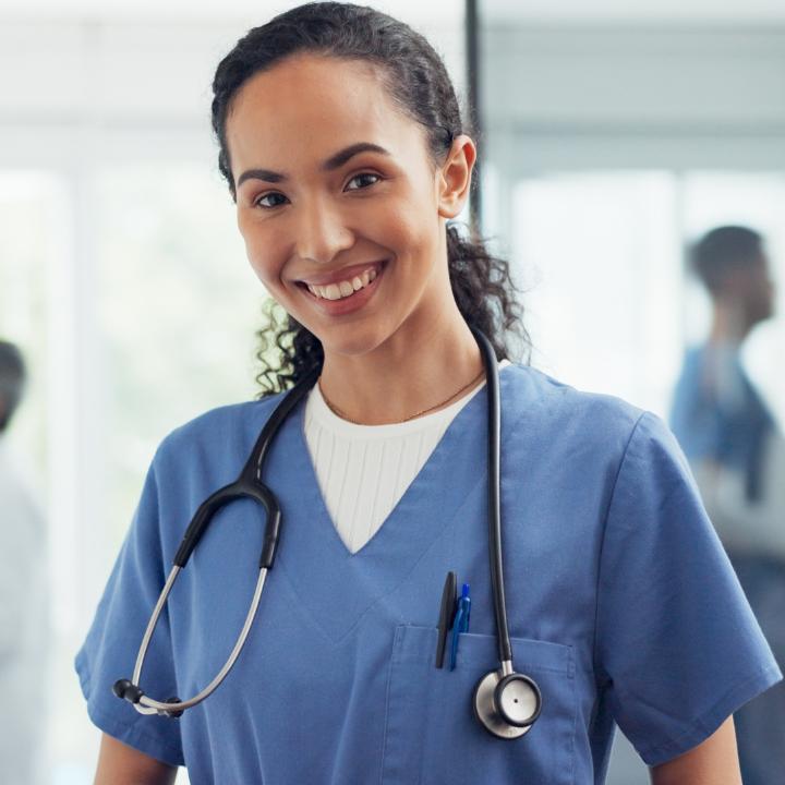 healthcare working wearing blue scrubs with a stethoscope around their neck